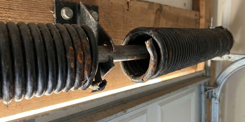 Broken garage door torsion spring with a visible gap between the coils